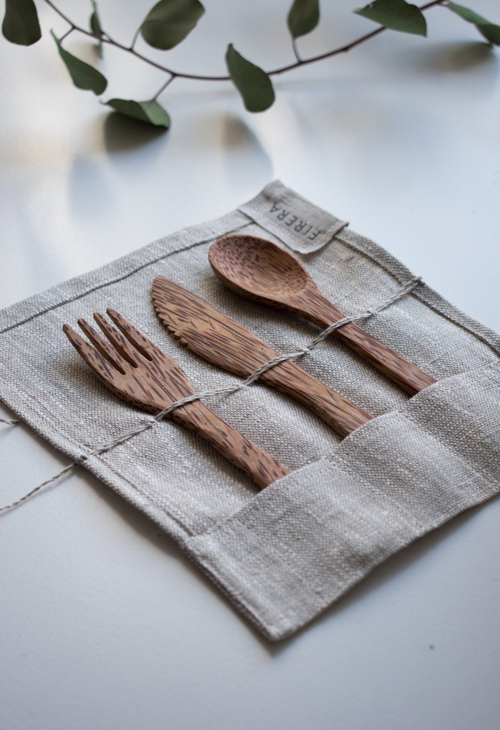 brown wooden fork, spoon, and knife on textile